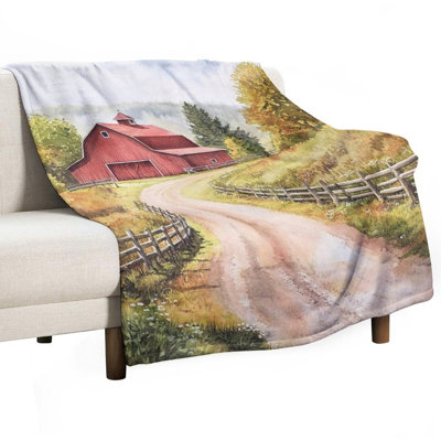 Jeté rouge en flanelle de luxe à côté de la route de campagne sinueuse, couverture douce et chaude pour le canapé-lit du salon