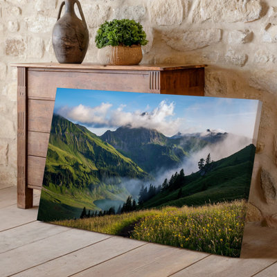 Canvas A Breathtaking Landscape Featuring A Lush Green Valley Nestled Between Wall Art Towering Mountains With Vibrant Wildflowers Canvas Wall Art