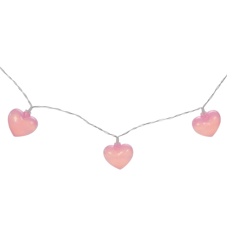 Single pink string heart isolated on light pastel pink background. Copy  space. Valentines day card. Flat lay. Stock Photo