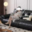 Causeuse-coussin modulable noire en cuir véritable