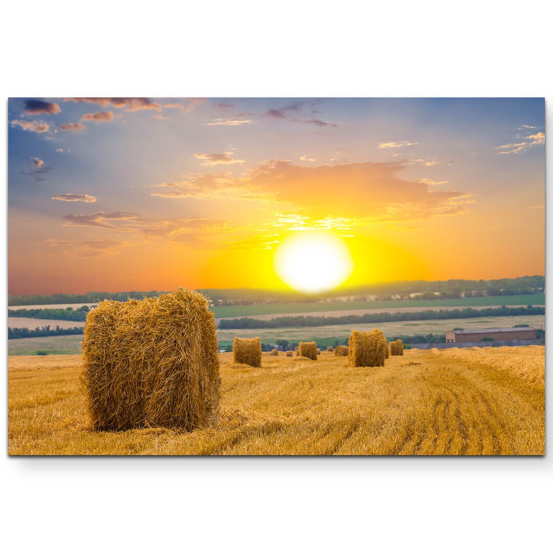 Leinwandbild Feld mit Strohballen und Sonnenuntergang