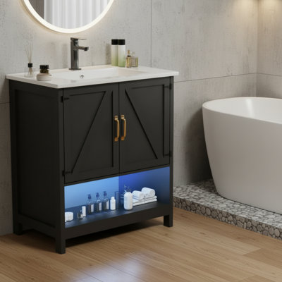 Meuble-lavabo noir, avec lavabo à DEL, portes à fermeture douce et support de rangement.