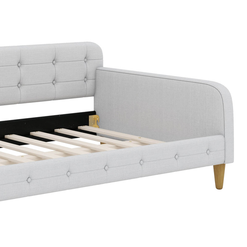 Lit de jour enveloppé dans un tissu d'ameublement et reposant sur des pieds robustes, Beige