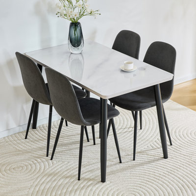 Ensemble de table et de chaises. Table à manger rectangulaire moderne, pouvant accueillir de 4 à 6 personnes. Comptoir en verre trempé blanc + panneau de fibres à densité moyenne inférieur, assorti à 4 chaises de salle à manger en lin et coton gris foncé avec pieds en métal.