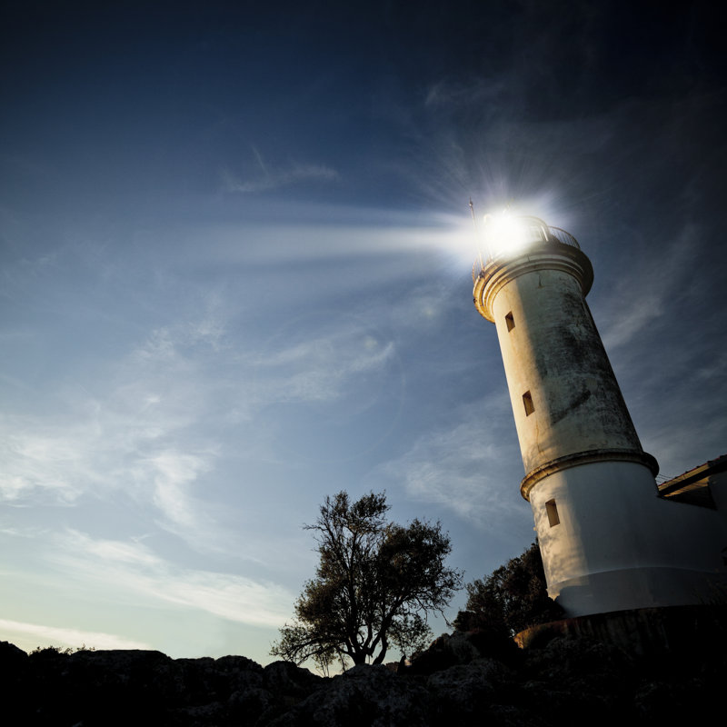 Low-angle View Of A Lighthouse At Twilight by Aylinstock - No Frame Print on Canvas, 122cm H x 122cm W