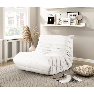Fauteuil de sol de luxe en microfibre beige, rembourrage haute résilience, fermeture éclair, supporte jusqu'à 136 kg, largeur d'assise 85 cm, style contemporain, finitions soignées, base antidérapante.