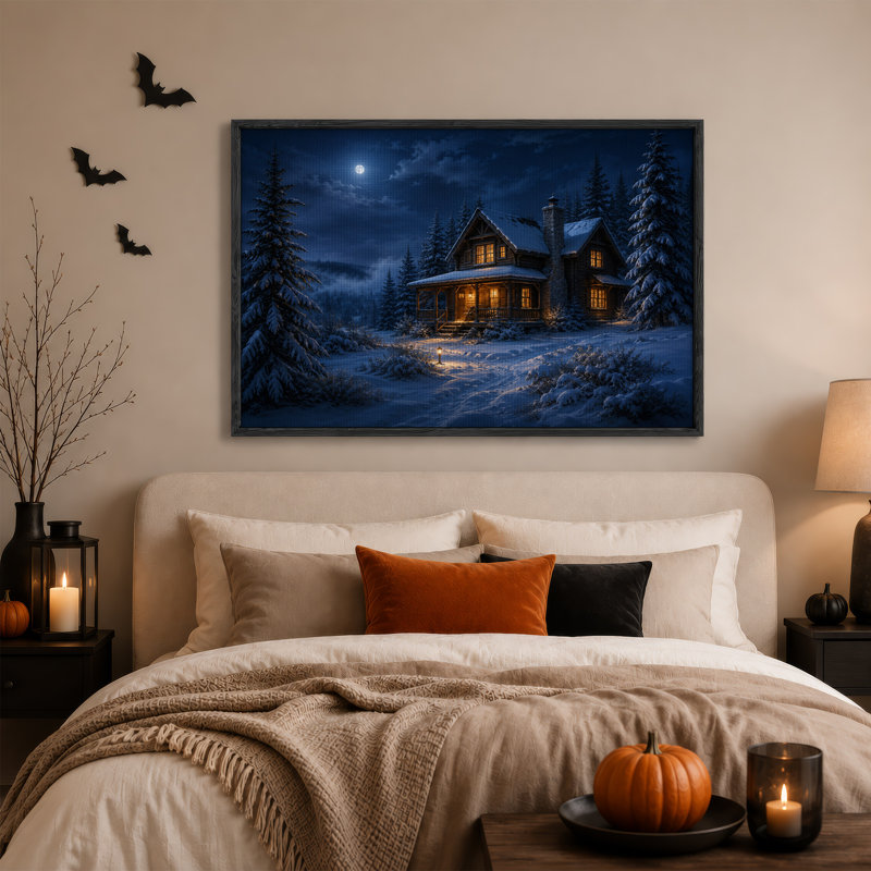 Cabane en bois rond enneigée aux fenêtres illuminées sous une toile murale d'Halloween, 18"H x 24"W