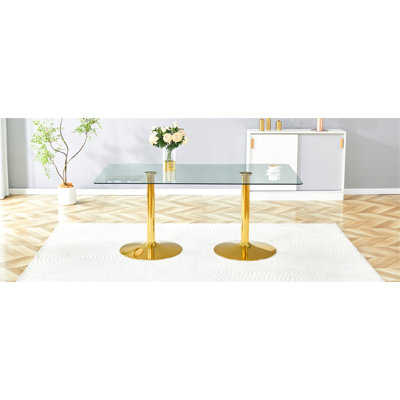 Un plateau de table en verre de 71 x 35,4 pouces et une table de salle à manger circulaire minimaliste moderne avec des pieds en métal doré électrolytique. Convient aux restaurants et aux salons.