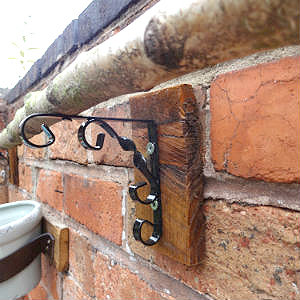 Wood attached to garden wall