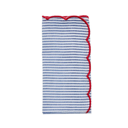 Blue and white striped linen napkin with a scalloped red stitched edge.