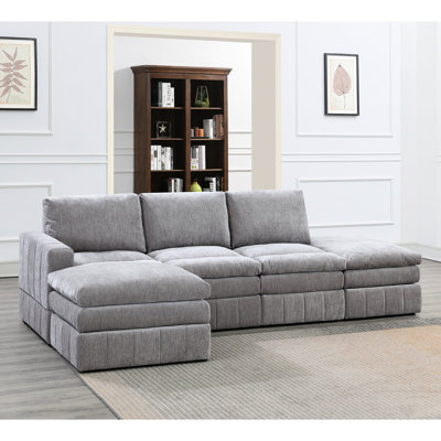 Canapé d'angle modulaire de 5 pièces en suède pour un espace de vie confortable et élégant. Tissu d'ameublement.