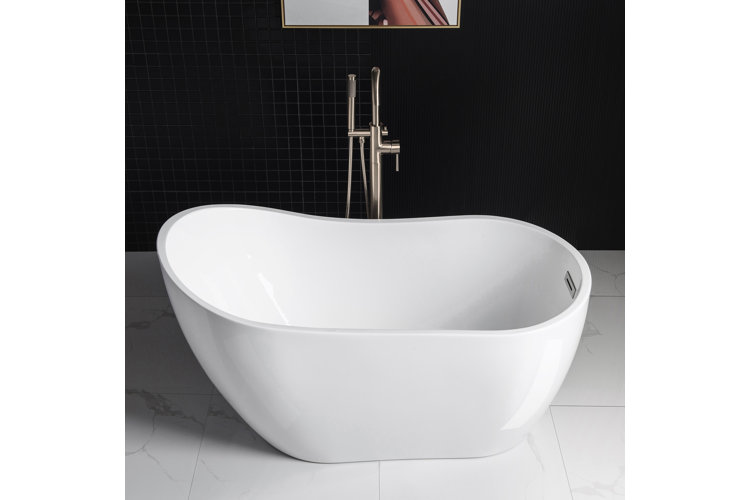 White freestanding acrylic bathtub with a floor-mounted faucet.