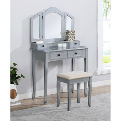 Coiffeuse en bois argenté avec banc, quatre tiroirs, miroir et tabouret offrant beaucoup d'espace de rangement.