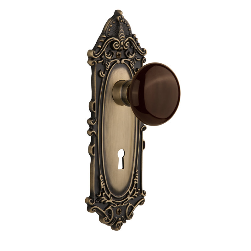 Victorian Plate with Decorative Keyhole and Brown Porcelain Door Knob, Antique Brass, 2-3/4”