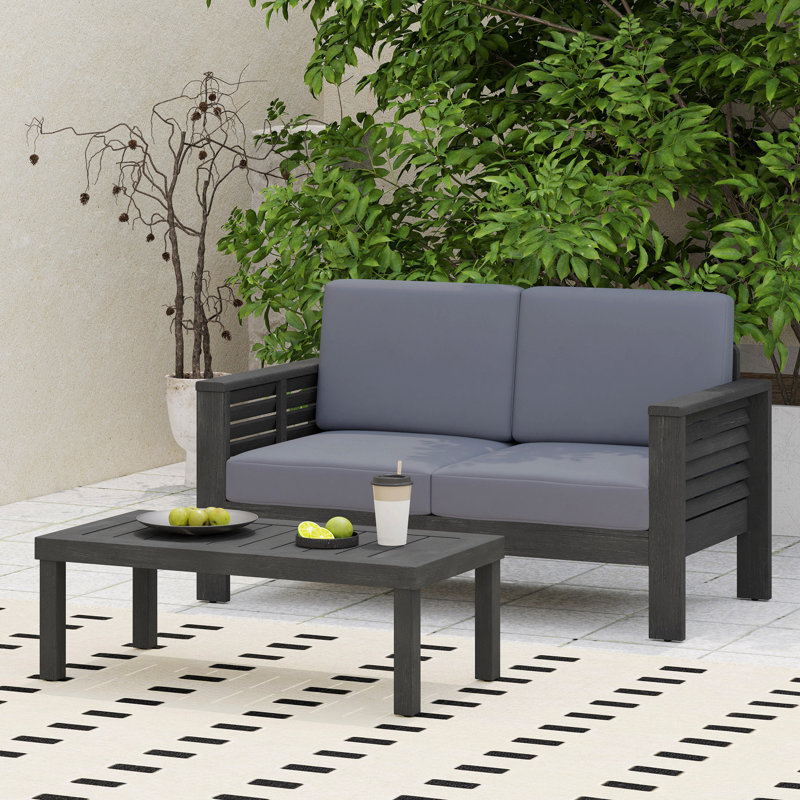 Ensemble de causeuse et table basse en bois d'acacia avec coussins