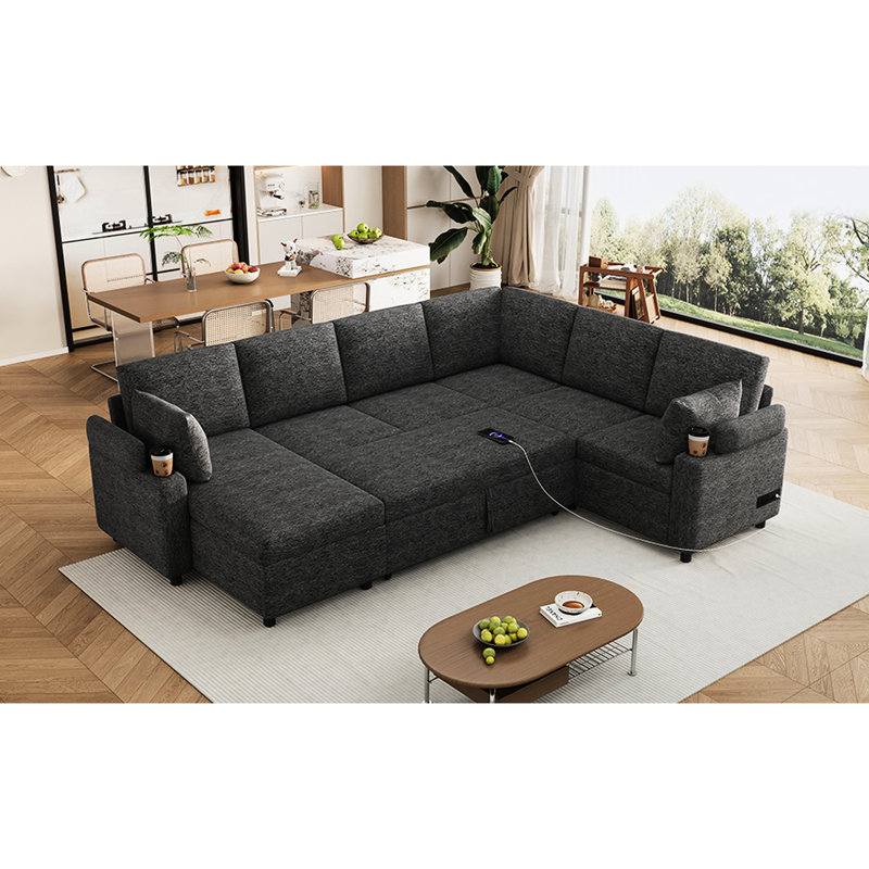 Lit confortable en forme de U gris avec compartiment de rangement et porte-gobelets avec lit escamotable, accoudoirs dissimulés