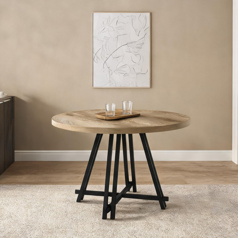 Round dining table with distressed oak finish top and black cross metal base, 47 inch