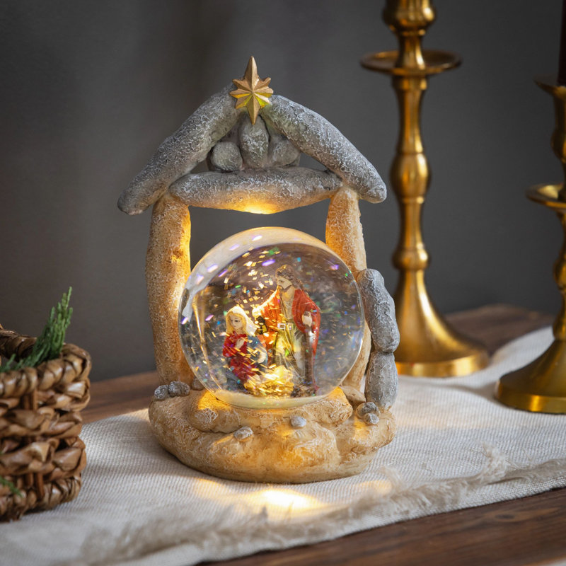 Boule à eau décorative de table en résine avec éclairage DEL, motif Nativité, 17 cm de hauteur.