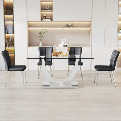 Ensemble de table et de chaises, ensemble de salle à manger en verre trempé de luxe subtil - 63 po x 35,4 po avec 4 chaises en polyuréthane noir avec un motif à rayures verticales sur le dossier. Pieds en métal argenté.