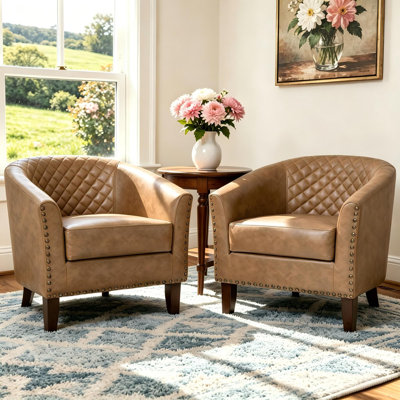Fauteuil demi-tonneau capitonné en similicuir Edvardas