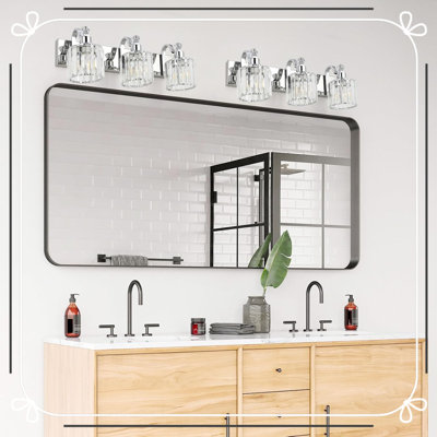 Luminaire de salle de bain moderne en cristal à DEL chromé au-dessus d'un miroir