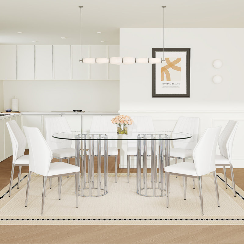 Ensemble de table et de chaises, table de salle à manger ovale en verre trempé de 71 pouces, double colonne argentée de style luxueux. Jumelé avec 8 chaises en polyuréthane blanc avec des pieds argentés. Hauteur de 37 pouces: dossier ergonomique en polyuréthane.