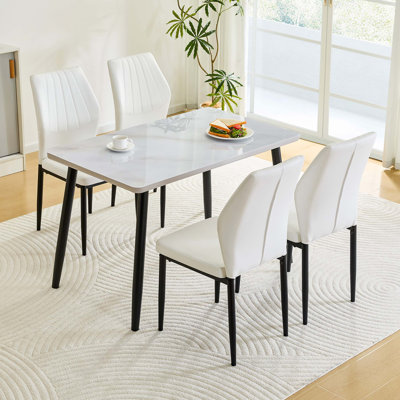 Ensemble de table de salle à manger rectangulaire et quatre chaises rembourrées comprenant un comptoir à double couche, un design à dossier en coquille et des pieds antidérapants protégeant le plancher.