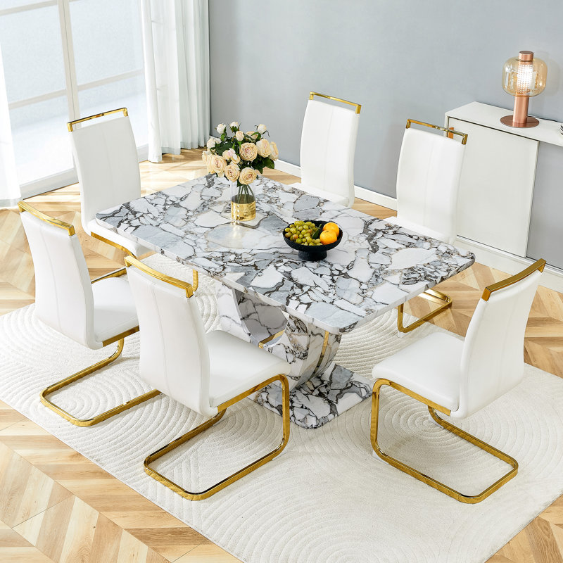 Ensemble de table de salle à manger moderne avec plateau en panneau de fibres à densité moyenne texturé blanc et bordure dorée, base en forme de U, chaises en similicuir incluses