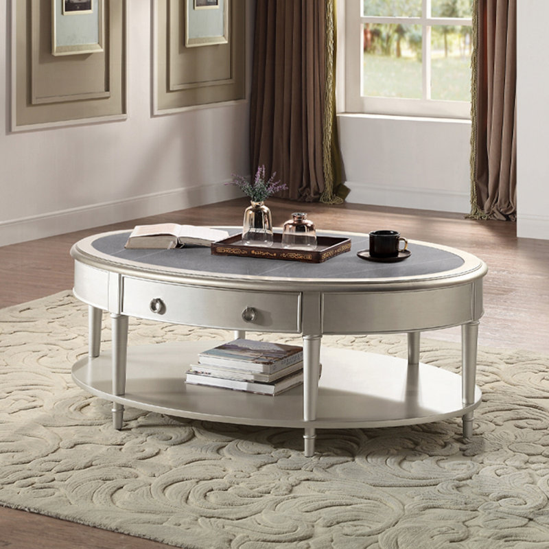 Table basse, pierre frittée et finition champagne
