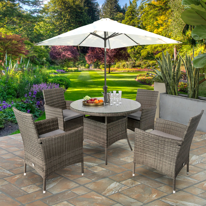 Twigg 4 - Person Premium All-Weather Wicker Patio Dining Set with Round Table , Cushions Included