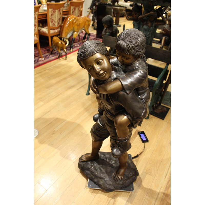 Boy Giving Girl Piggyback Ride Statue