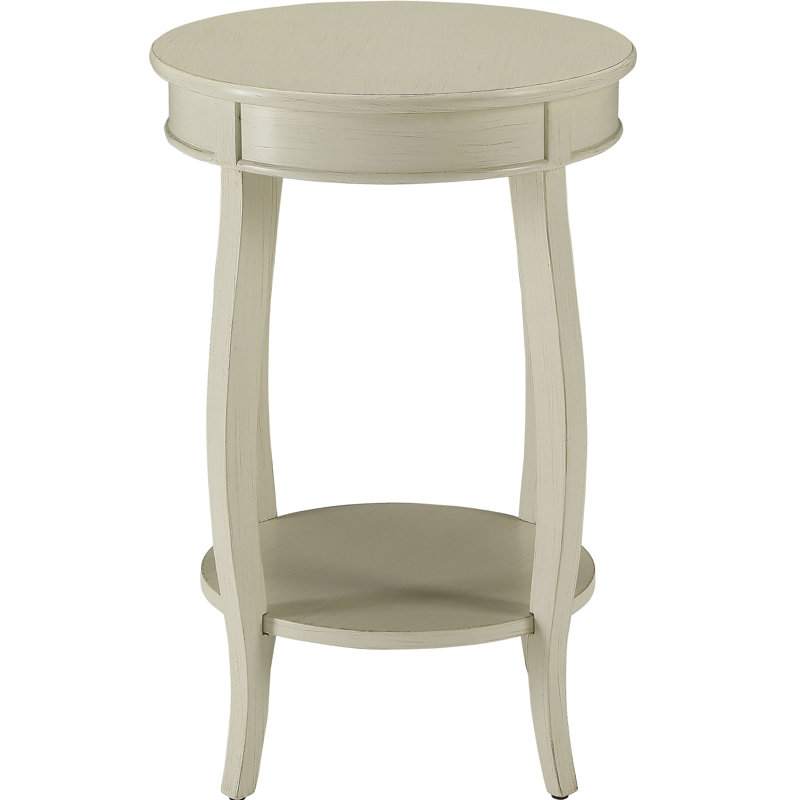 Table d'appoint ronde blanche antique avec étagère, s'harmonisant avec le décor de la pièce. Étagère en bois pour le rangement et la présentation.
