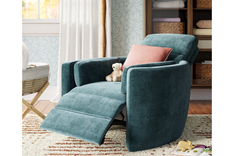 A teal recliner in the reclined position with a pink throw pillow and a small teddy bear on top.