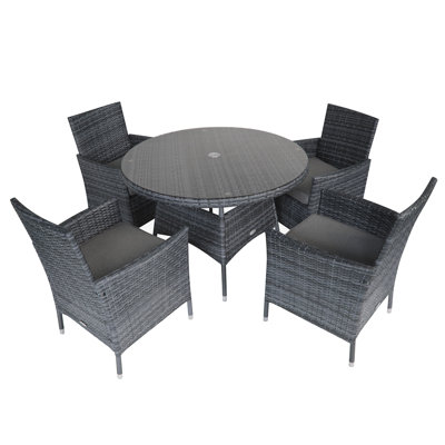 Nohemi 4 - Person Wicker Patio Dining Set with Round Table , Cushions Included