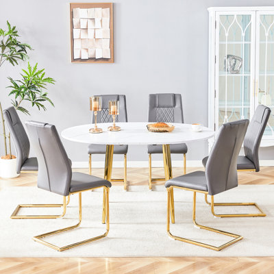 Ensemble de table et de chaises extensibles avec 6 chaises gris foncé et pieds en métal doré. Forme ronde, idéale pour diverses occasions. Siège en polyuréthane souple. Style moderne avec pieds dorés. Mécanisme d'extension. Facile d'entretien.
