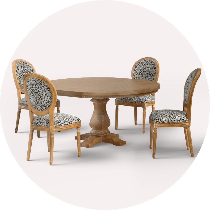 Round wooden table with four upholstered chairs
