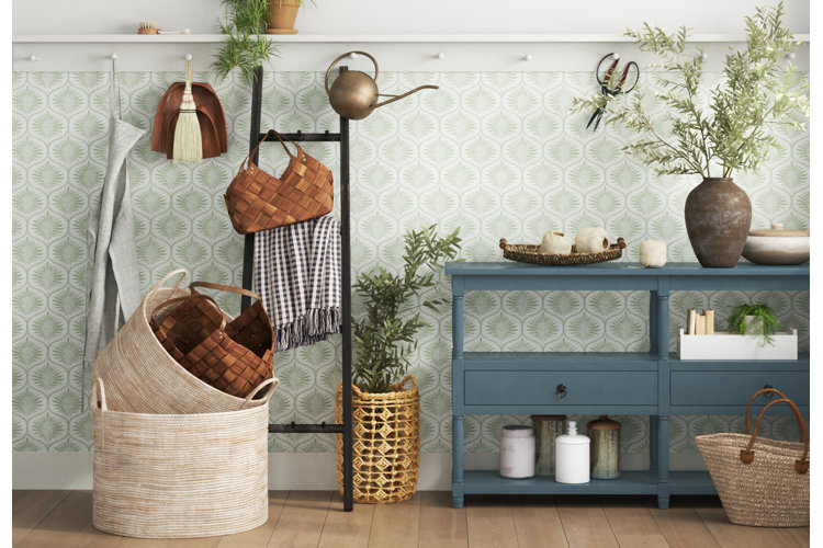 traditional entryway with a blue console table, wall hooks, and storage baskets