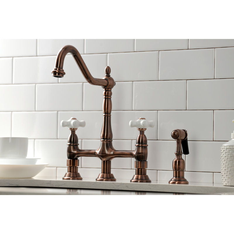 Kingston Brass Heritage Two-Handle 4-Hole Deck Mount Bridge Kitchen Faucet with Brass Side Sprayer, Antique Copper