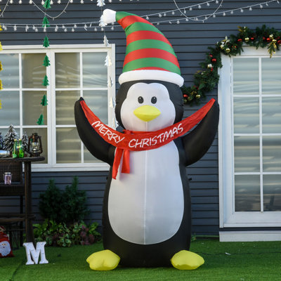 Pingouin tenant une bannière gonflable Merry Christmas
