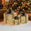 Coffret-cadeau de 3 pièces à paillettes dorées avec décorations de pommes de pin et de baies, illuminé pour les fêtes de fin d'année.