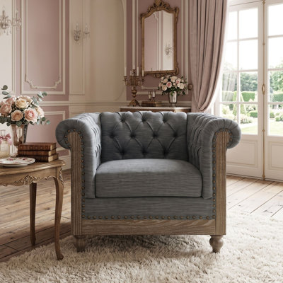 Fauteuil club capitonné d'inspiration Chesterfield avec accoudoirs