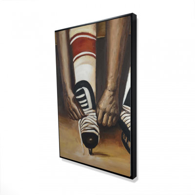 Hockey Player Ties His Skates Print On Canvas