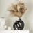 Nestled In A Hollow Ceramic Vase-64810638