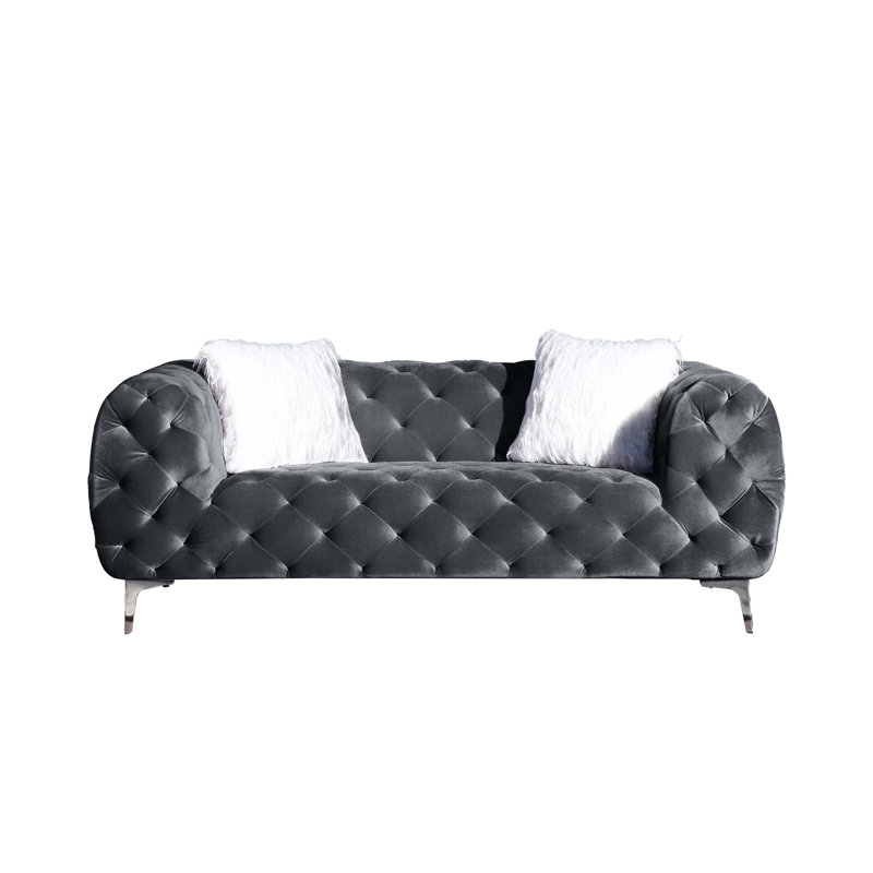 Élégant canapé de salon en velours avec capitonnage et repose-pieds, idéal pour créer un environnement luxueux et confortable