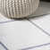 Tapis blanc / gris à motif de losanges minimalistes Bertrice