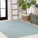 Tapis intérieur / extérieur à chevrons concentriques carrés turquoise / gris clair