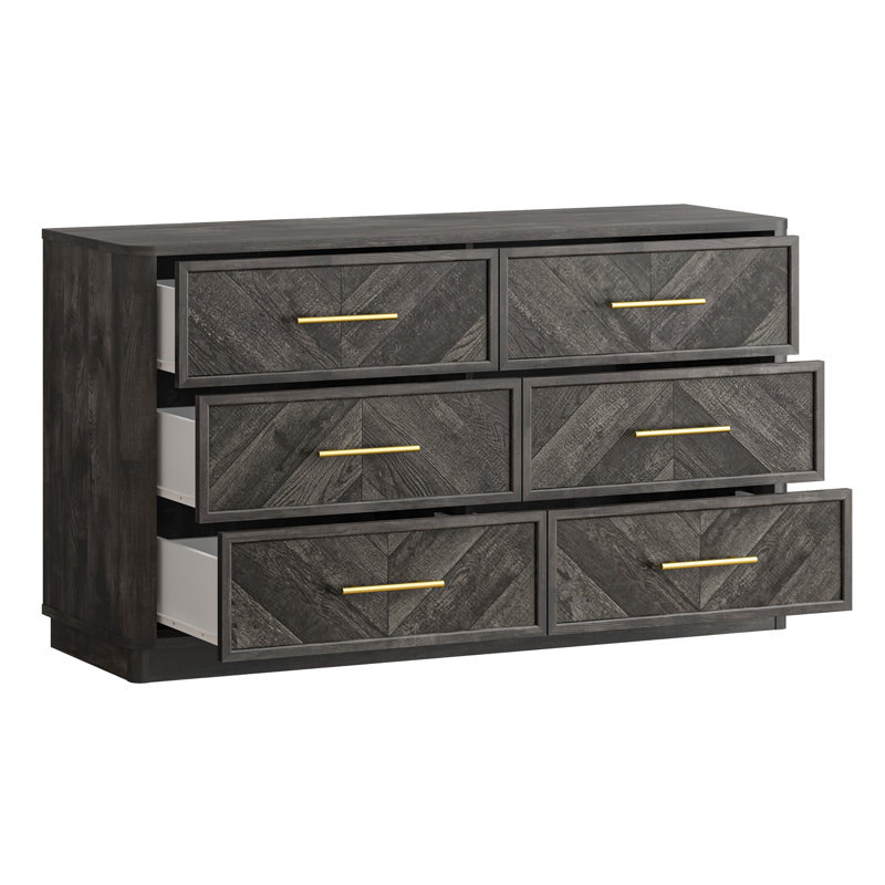 Commode moderne à 6 tiroirs de 140 cm de large, avec façades de tiroirs à motif en chevron et poignées dorées.