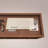 Brown Solid Wood Display Counter with Tempered Glass Top, Three Drawers, and Open Shelf Storage