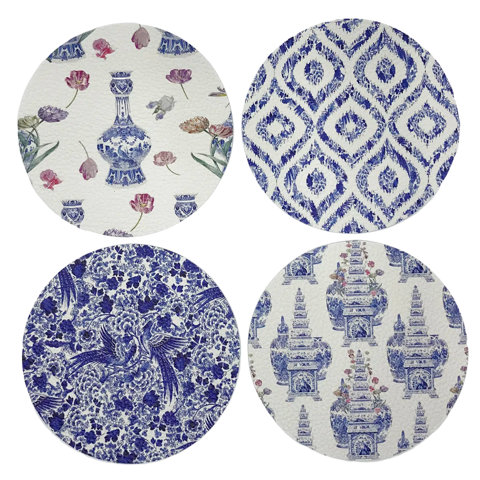 Set of four round placemats with blue and white patterns