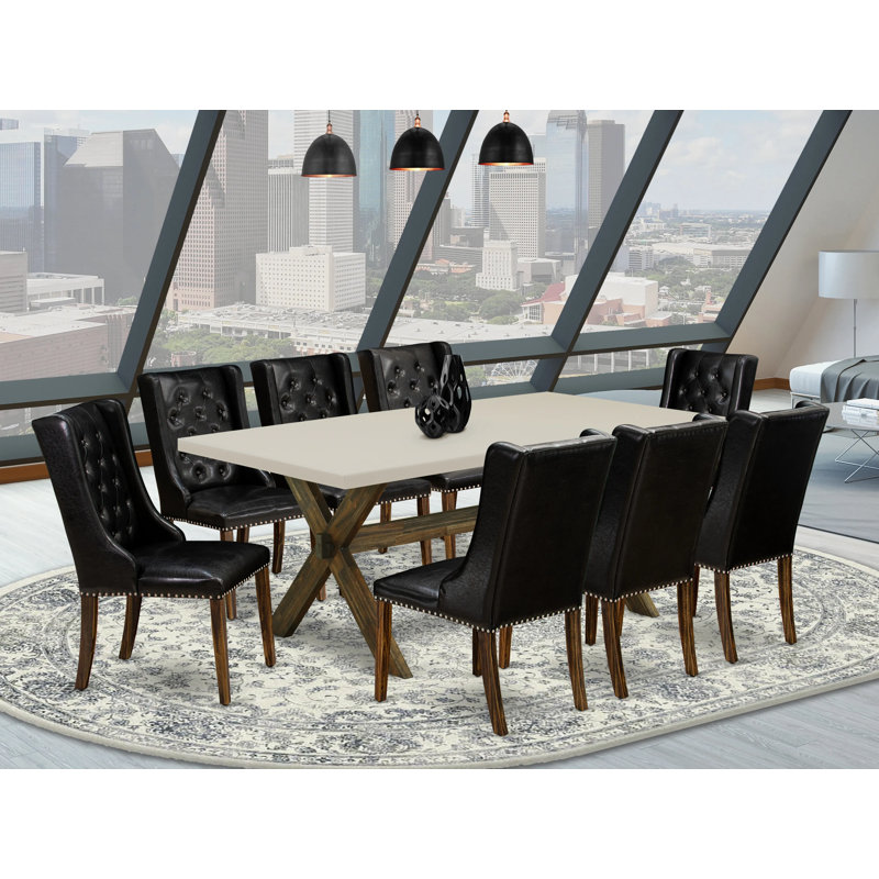 L'ensemble de mobilier de salle à manger 9 pièces comprend une table de salle à manger rectangulaire avec des pieds en X et 8 chaises Parsons en similicuir noir